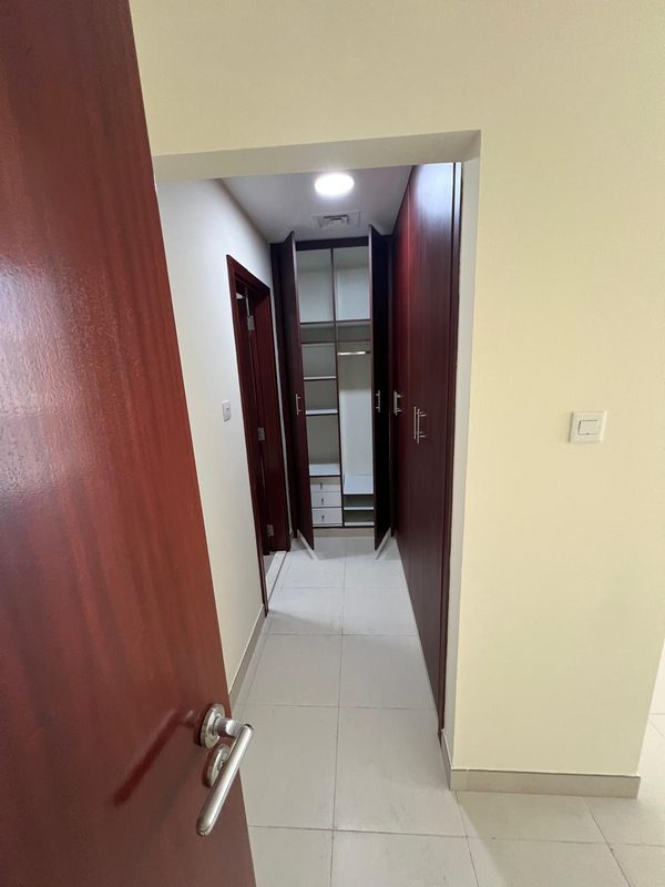 Passage with fitted wardrobes before the works, later opened to the living room and rebuilt for the guest washroom