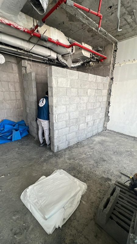 Team member inside the new blockwork walls of the guest bathroom