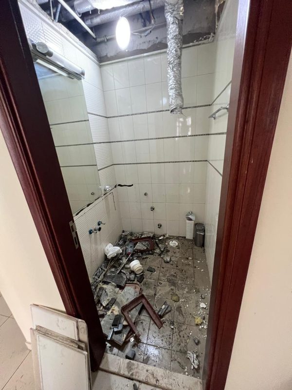 Old bathroom being stripped out before the walls were removed for a bigger master bathroom