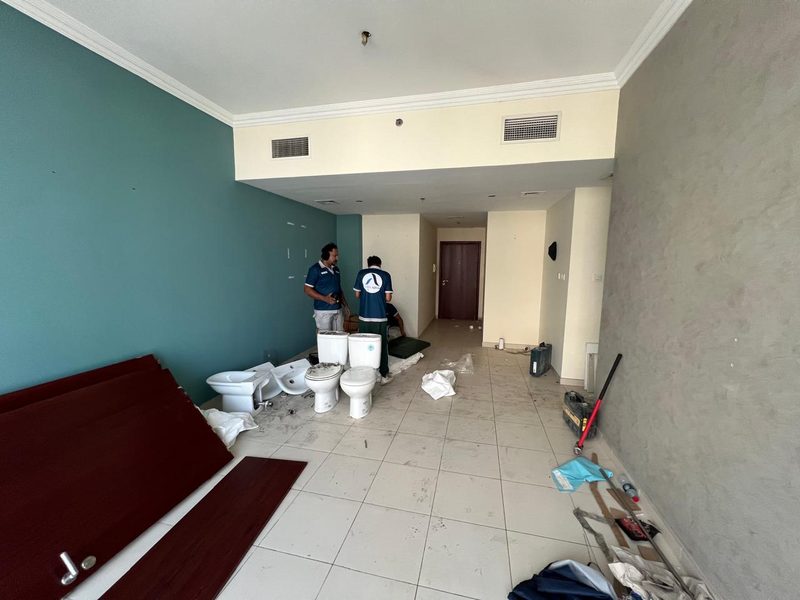 Room that became the master bedroom, with the team removing old sanitaryware at the start of the works