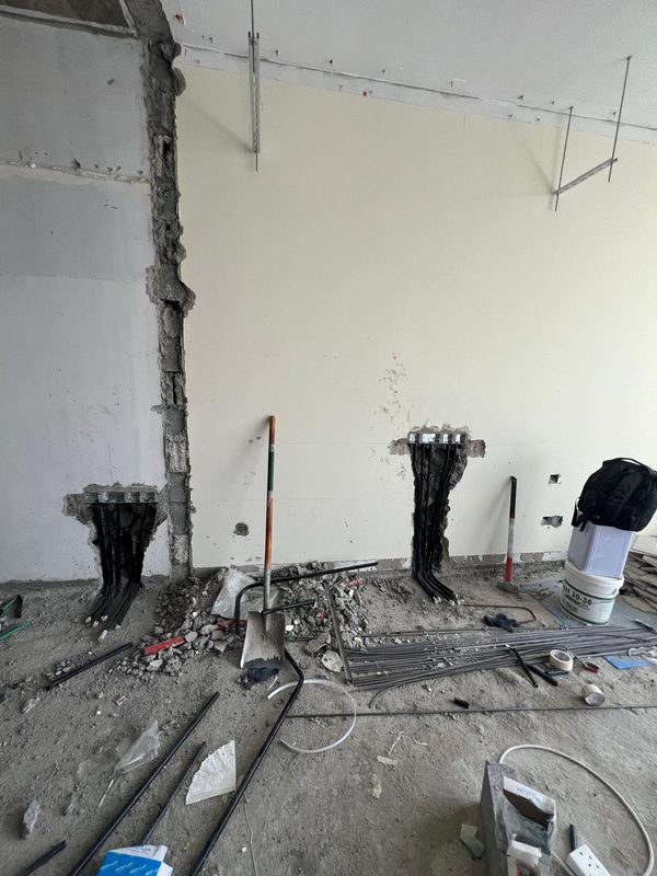 TV wall during the works, chased for new cabling at two outlet positions